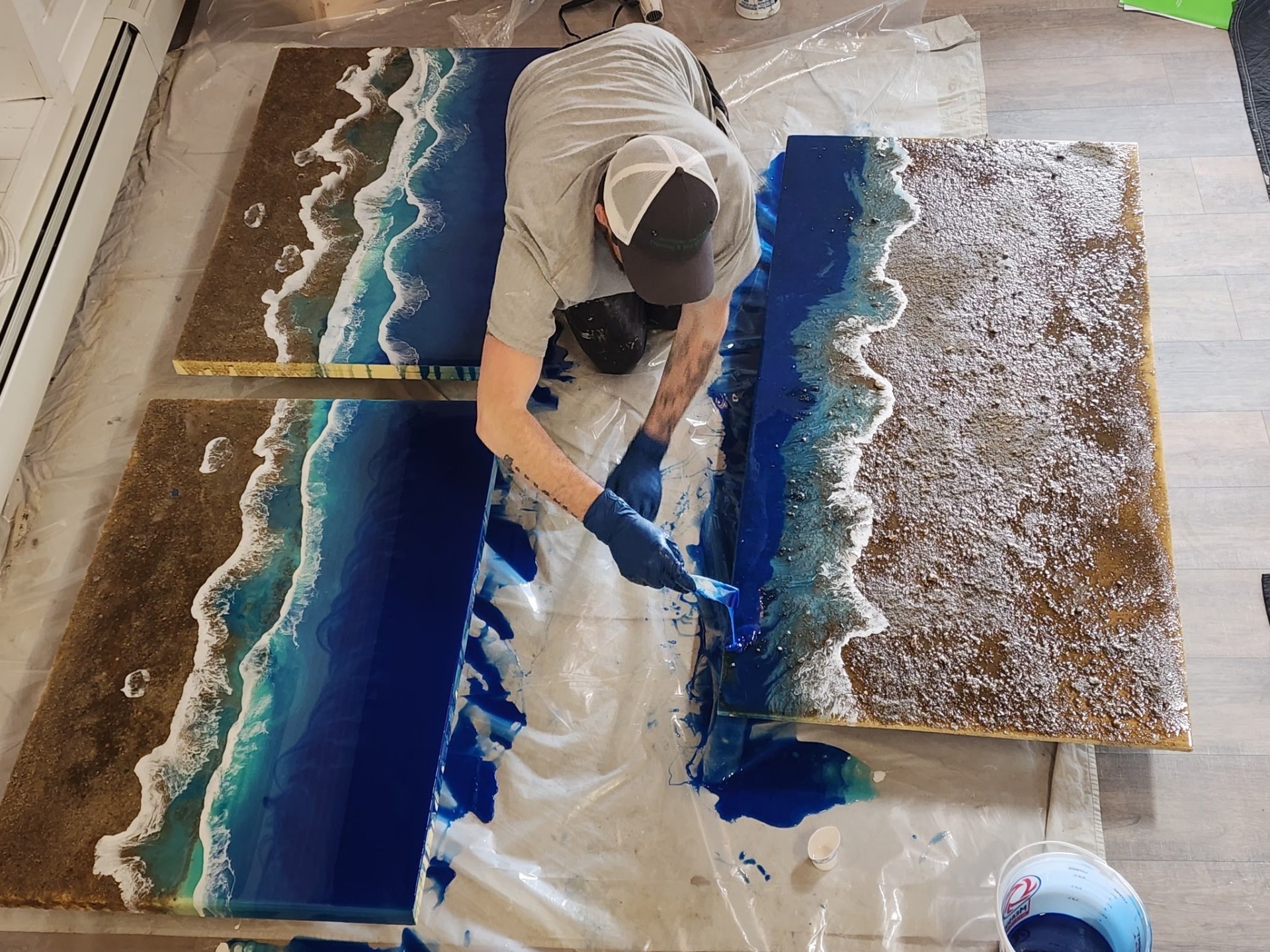 Artisan pouring custom ocean-themed epoxy resin panels, South Shore MA